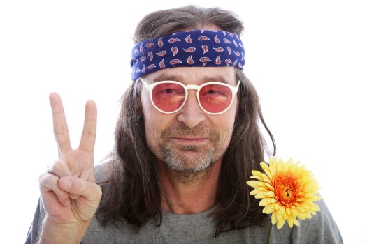 Male hippie making a peace sign